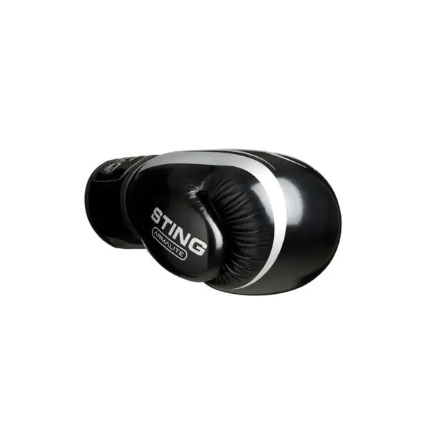 A sleek, shiny Sting Armalite Boxing Glove in black and white, with STING boldly written on it, is angled to display its side.