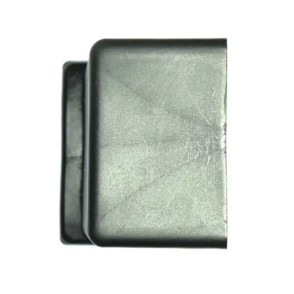 Close-up of a Rubber Foot 60mmx60mm, rectangular and slightly curved with visible scratches and a matte finish. The plain white background highlights its texture and shape.