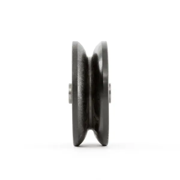 Side view of the ATX® Pull-Up Add-On for Rigs and Racks, showcasing a black metal pulley wheel with a central groove against a white background. The metallic texture and intricate details are clearly visible.