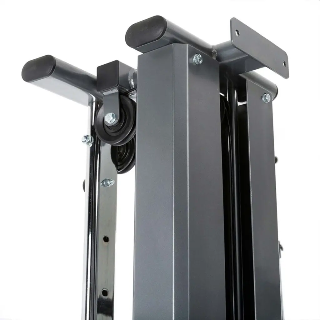 Close-up view of a metallic gym machine part with sleek gray steel columns, black handles, and visible cables and bolts. The design appears sturdy and polished, ideal for strength training on a wall-mounted cable machine.