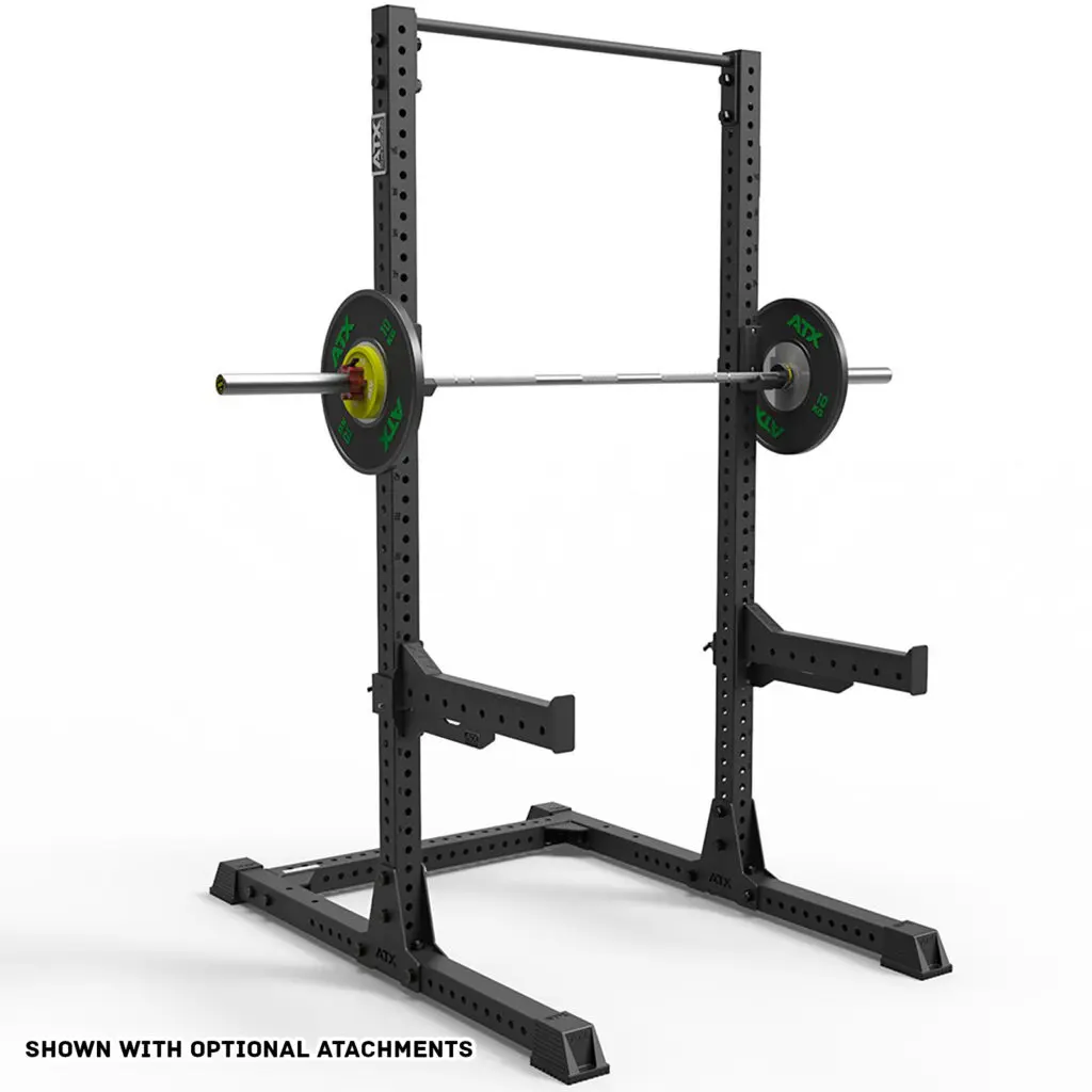 The ATX® Half Rack 810 features adjustable safety bars and a mounted barbell with green and black weights, set against a plain white background.