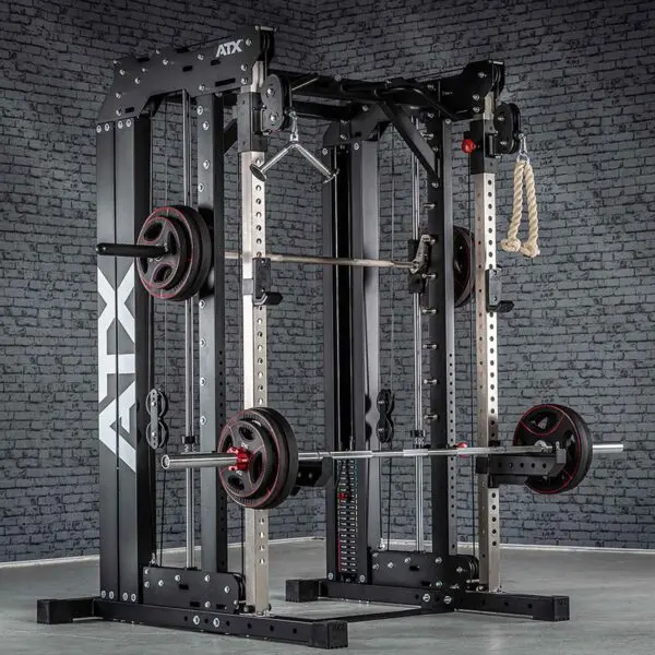 An ATX® Smith Cable Rack Weight Stack, black in color, features weightlifting equipment like a barbell with weight plates, a pulley system, and rope. It is positioned against a gray brick wall.