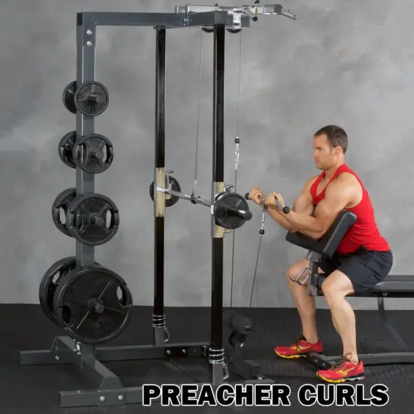 A person in a red sleeveless shirt performs preacher curls with the Ironmaster IM2000 Self-Spotting Smith Machine at the gym. Weight plates are visible, and PREACHER CURLS is written at the bottom of the image.