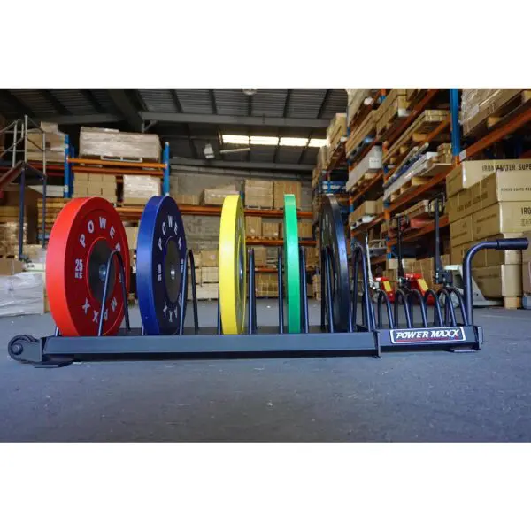 In a warehouse filled with shelves and boxes, Bumper Weight Plate Toaster Racks neatly organize colorful weight plates.