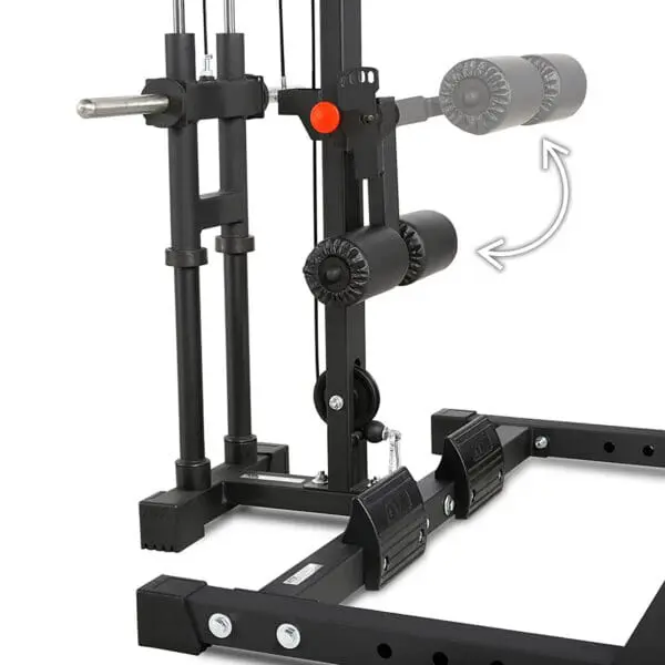 A close-up view of the ATX® Half Rack, a black gym machine with padded rollers and metal bars for leg exercises, features an arrow pointing to adjustable parts for customized workout positions.