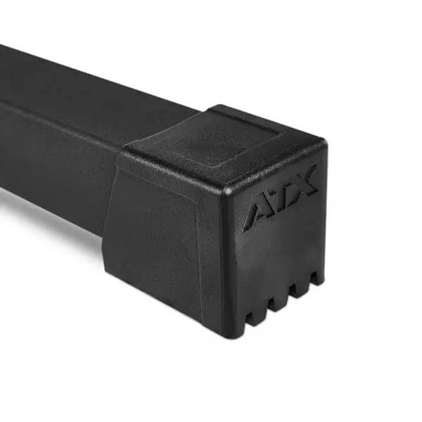 Close-up of the ATX® Half Rack, a black rectangular object featuring a prominent AAX logo on one end. The smooth surface transitions into a grooved texture along the bottom edge, suggesting an industrial or mechanical design purpose.
