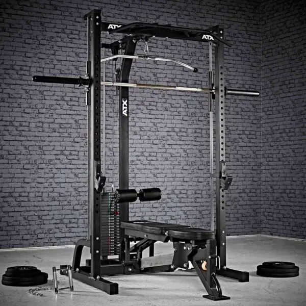 A home gym setup includes the ATX® Smith Machine System Stack Weight 115 kg, featuring a bench, barbell, and adjustable weights. The textured gray brick wall serves as the background, with weight plates scattered on the floor.