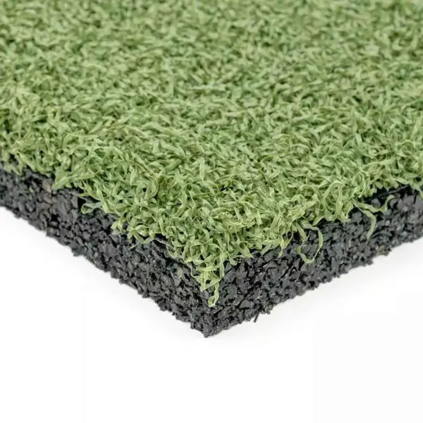 Close-up of GymFloor RTS 50x50@20mm System, showing the textured green synthetic turf layer over a black rubber base, highlighting the contrast between the lifelike grass top and sturdy foundation.
