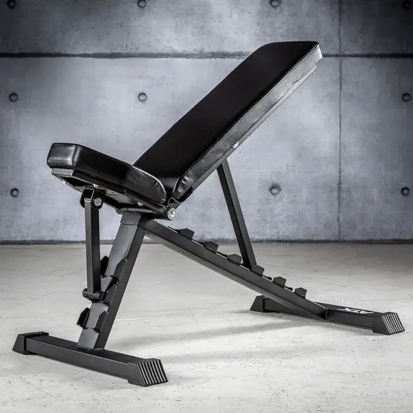 The ATX® Multi Bench 102, now discontinued, is in an industrial-style space with concrete walls. Its set to an incline position and features a padded seat and backrest.