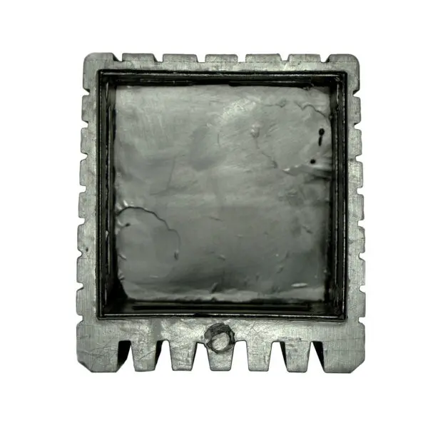 Close-up of the Rubber Foot 50mmx50mm, showcasing its square shape with a rough, textured metallic surface and notched edges, resembling an industrial component.