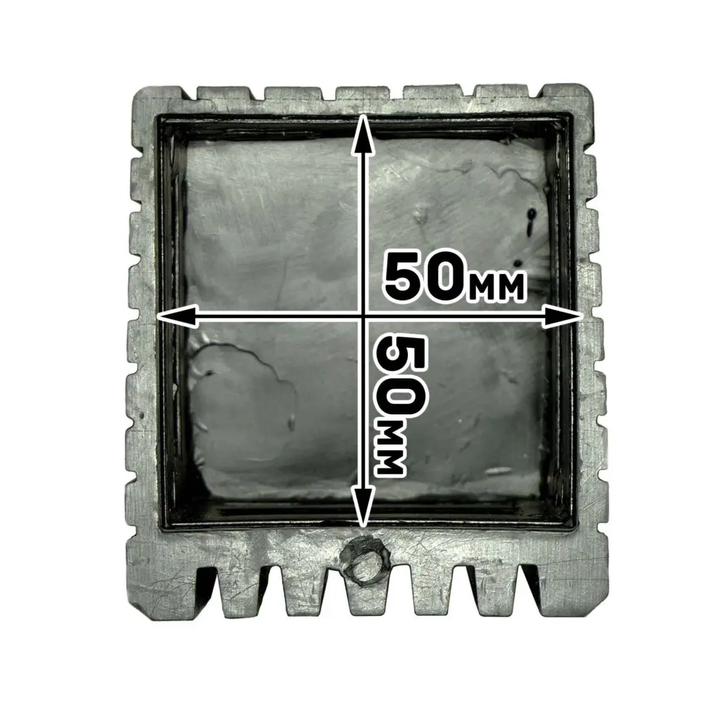 The Rubber Foot 50mmx50mm is a metallic mold with serrated edges on three sides, a bottom protrusion, and an interior measurement of 50mm x 50mm. The inner surface is textured and unfinished.