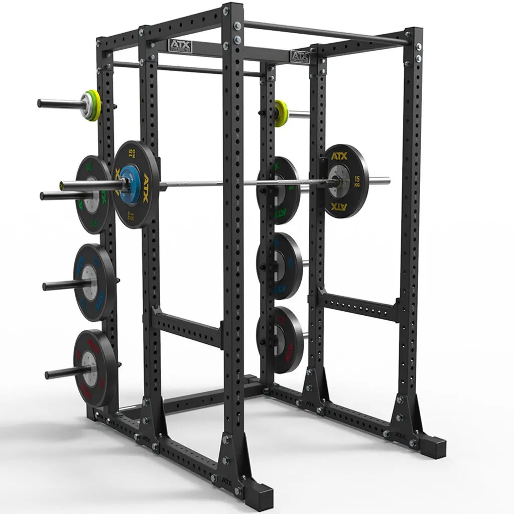 The ATX® Power Rack 750 Deluxe Set is a black metal structure featuring multiple neatly arranged weight plates and barbells. Its sturdy with adjustable holes for various exercises, ensuring an organized gym setup.