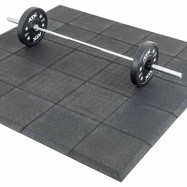 A barbell with weight plates is centrally positioned on a set of Shock & Sound Tile 30mm System gym mats. These interlocking, square rubber mats have a textured surface and offer cushioning for weightlifting or exercise.