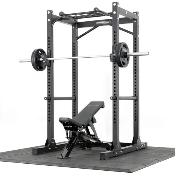 A black power rack with a pull-up bar, loaded barbell, and adjustable bench on Shock & Sound Tile 30mm System rubber flooring, perfect for any home gym or fitness center.