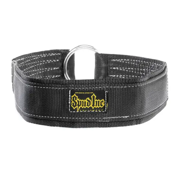 The SPUD INC Reverse Hyper Strap is a black collar with reinforced stitching and a metal D-ring. Featuring the Syndicate Gear yellow and black logo patch on the front, it is wide and designed for durability.