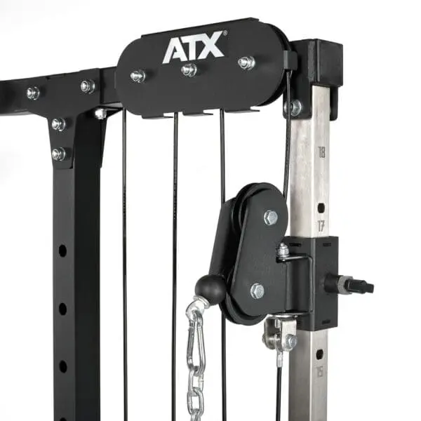 Close-up of the ATX® Cable Crossover Plate Loaded machine, featuring pulleys, adjustable weights, chain, and a sturdy black and silver metal frame for effective strength training.