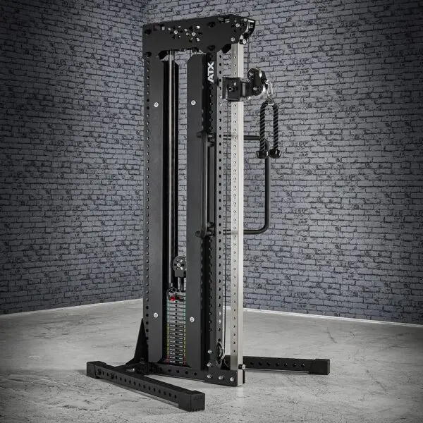 In a gray gym setting with a brick wall backdrop, a black and silver cable station stands ready for action. This versatile equipment is designed for strength training, featuring a weight stack and adjustable pulleys.