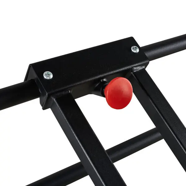Close-up of the ATX® Wall Bar Gym, a black metal structure reminiscent of Swedish Bars, featuring a striking red button in the center. The frame is bolted, highlighting the vibrant button against the dark metal.