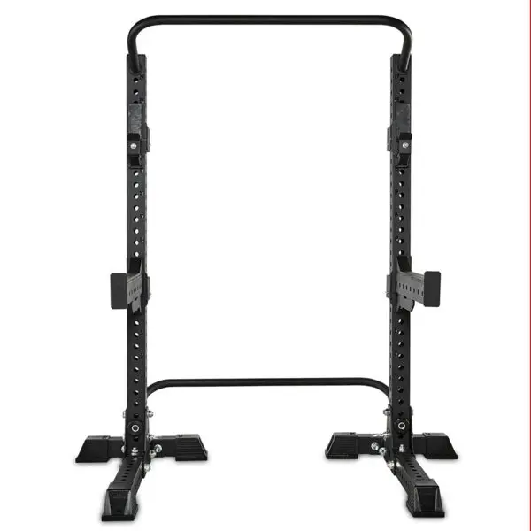 The ATX® Squat Stands Brace is a black, adjustable squat rack featuring safety spotter arms and numerous height adjustment holes. Its base has wide feet for stability, all set against a plain white background.