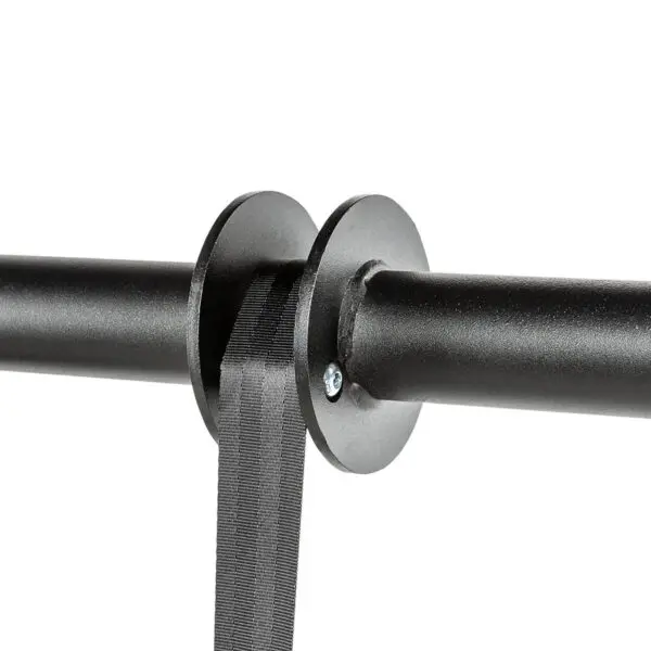 A close-up of a black wall-mounted belt stanchion, featuring a retractable black belt attached to a circular end piece, is secured with a visible screw on a plain white background. Note: This product is not the ATX® Forearm Training Set.
