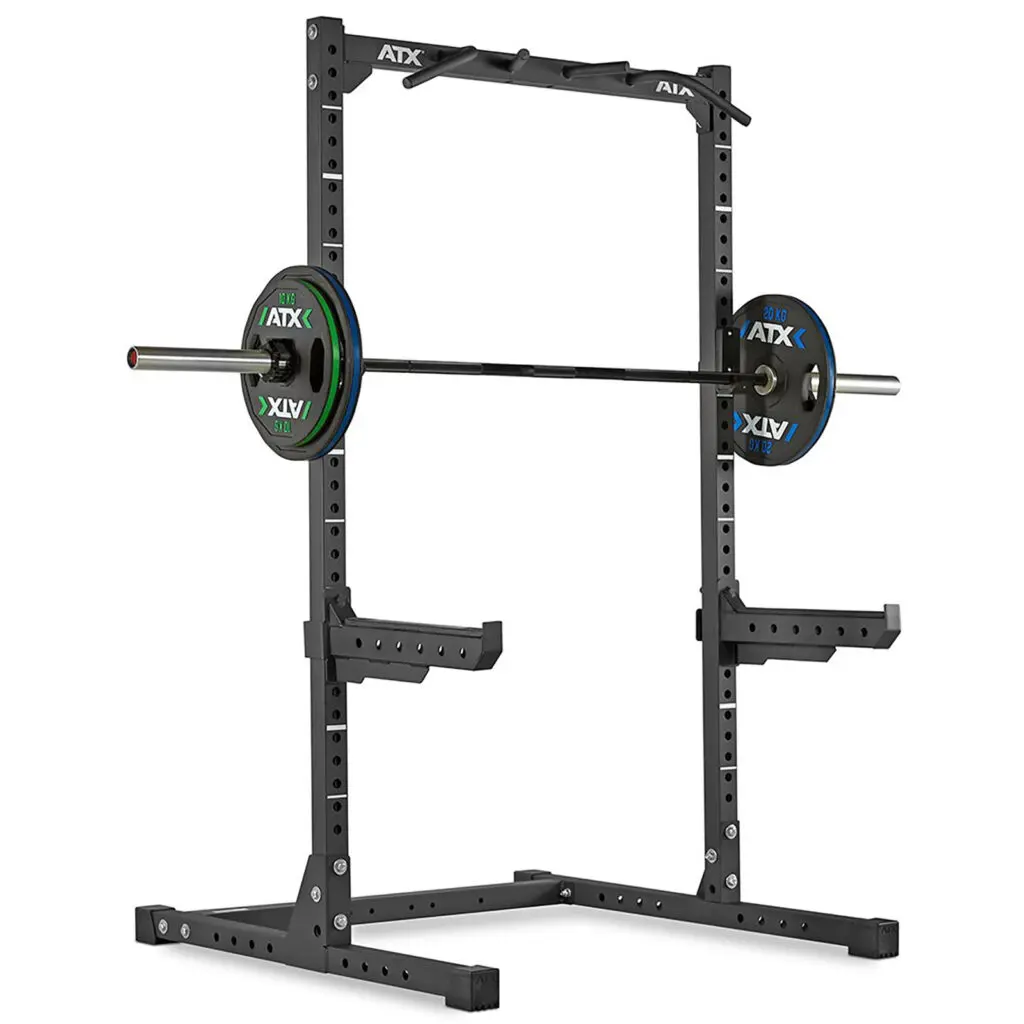 The ATX® HRX-620 Half Rack features a sturdy metal frame with adjustable hooks and safety arms, complete with a barbell and colorful weight plates—ideal for strength training exercises.
