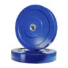 Two black Olympic bumper weight plates are pictured, one standing upright against another lying flat. Both bear the 20 kg engraving and have a central metallic hole for mounting on a barbell.