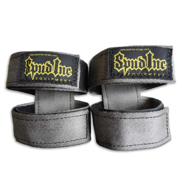 The Spud Inc 5R Barbell Shield features gray fabric wrist straps with black patches and yellow Spud Inc branding, designed for fitness or weightlifting, secured with Velcro closures.