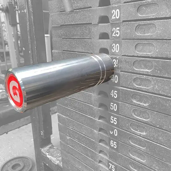A close-up of the GymPin 2 Original inserted at the 40-lb level in a grayscale weight stack highlights its metallic pin and striking red logo. Visible weight increments range from 20 to 65 pounds, facilitating precise workout tracking.