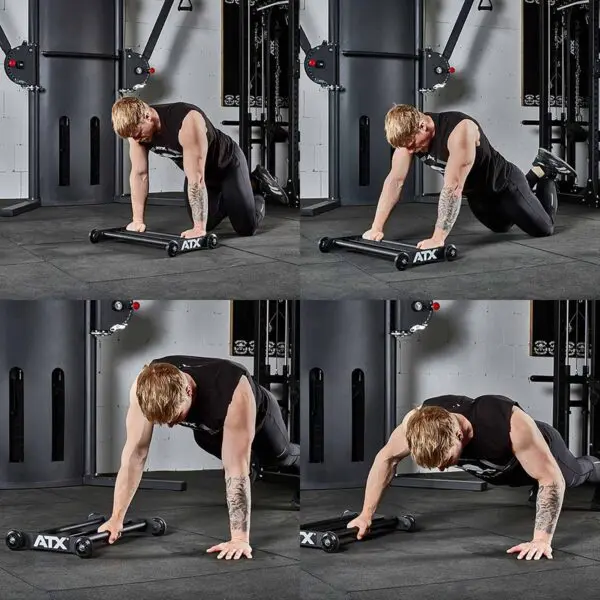 A person performs an ab roller exercise on a gym mat, engaging their core with precision. The sequence depicts kneeling, rolling forward, extending the body, and returning to the start. Clad in a sleeveless black shirt and pants, they are surrounded by gym equipment like the ATX® Glute Ham Roller in the background.