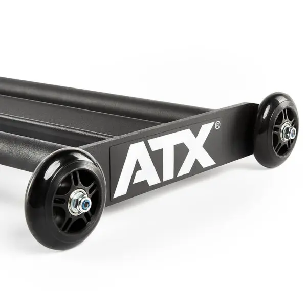 A close-up of a black ATX® Glute Ham Roller showcases two robust wheels and a sturdy metal frame, set against a plain white background.