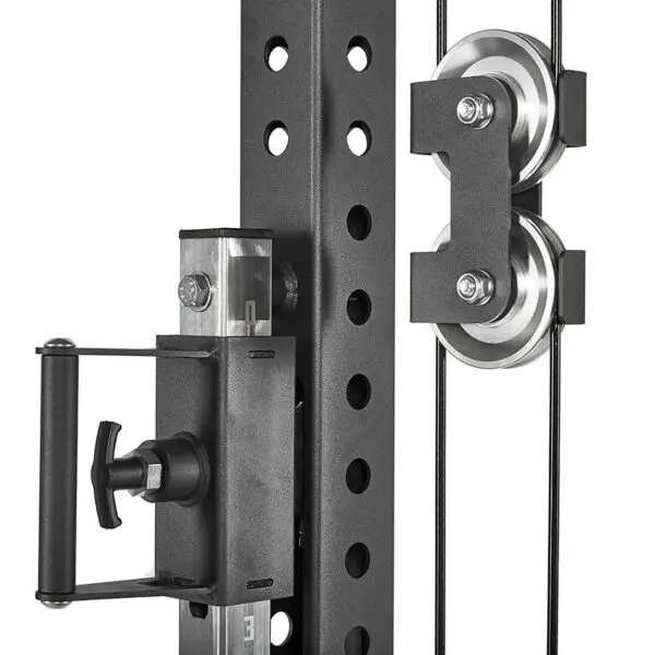A close-up of the ATX® Trinity Tower 135 kg showcases a black cable pulley system on a metal exercise rack, featuring two metal pulleys with cables and a handle with an adjustable knob on the left.