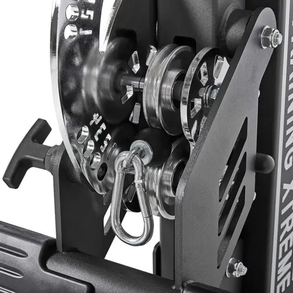 Close-up of the ATX® Trinity Tower 135 kg with a black and silver pulley mechanism, showcasing gears, hooks, and cables that highlight the detailed engineering of this exercise machine.