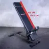 The Ironmaster Head Extension SB is an adjustable workout bench featuring a black padded surface, a sturdy metal frame, and a backrest angled at 41 inches (104.1 cm), placed on a textured floor against a plain backdrop.