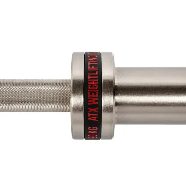 Close-up of the ATX® Training Weightlifting Bar, showcasing its silver finish and knurled grip for better hold. It features a black and red ring with ATX WEIGHTLIFTING text, emphasizing the brands sleek design.