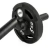 Close-up of a black FAT EZ Curl Bar weight plate labeled 5 KG, mounted on a barbell. The plate features cut-out handles for easy grip.