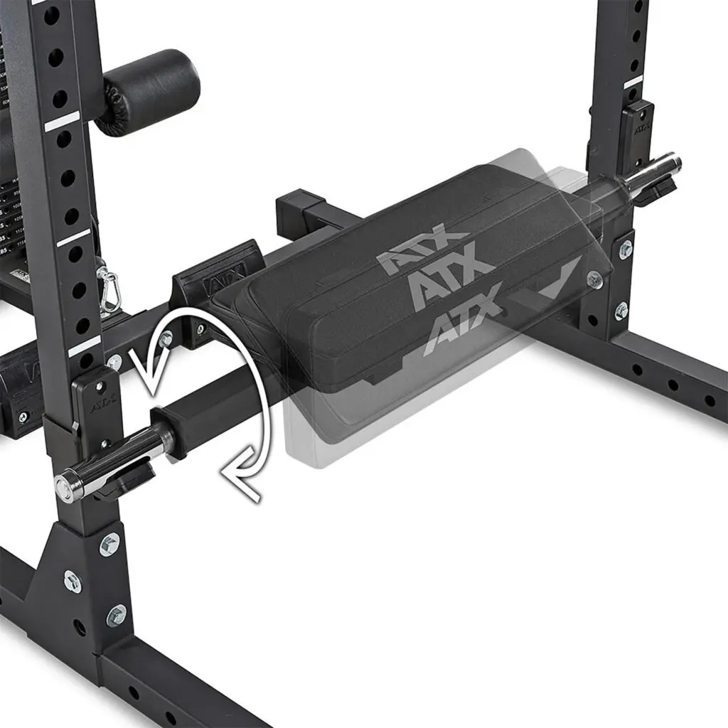 Close-up of an ATX® Hip Thruster Attachment showing its adjustable padded bench with a sliding mechanism, indicated by arrows. The metal frame includes numbered markings for height adjustment.