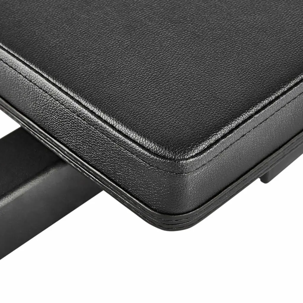 Close-up of a black leather bench seat with visible stitching, attached to a sturdy structure. The leather texture and solid build are highlighted, featuring the innovative ATX® Hip Thruster Attachment for enhanced workout versatility.