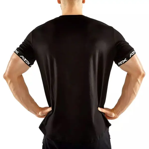 A person in an ATX® Training Shirt BLACK, featuring ATX text on the sleeves, stands with their back to the camera, hands on hips against a plain white background.