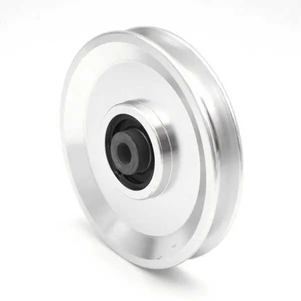 A plain background showcases a shiny silver 115mm Aluminium Pulley with a black central hub. This cylindrical wheel, featuring a smooth design, has a 10mm inner diameter and is suited for mechanical systems.