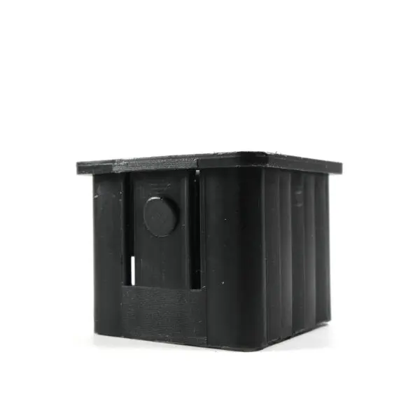 A compact black rectangular plastic box features ribbed sides and a circular protrusion on one side, displayed against a white background. This product is the Upright Sleeve Insert 40x40.