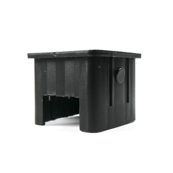 The Upright Sleeve Insert 40x40 is a black, plastic rectangular cap featuring a hollow center and a small circular protrusion on one side, with a slightly textured surface.