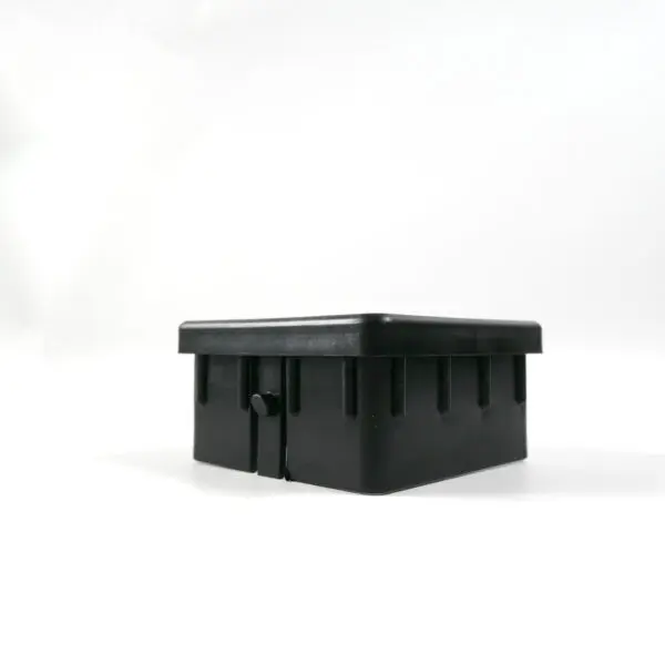 The Upright Sleeve Insert 75x75 is a black rectangular plastic container with a lid, adorned with small notches along the sides. Its showcased on a white background and angled slightly to the left.