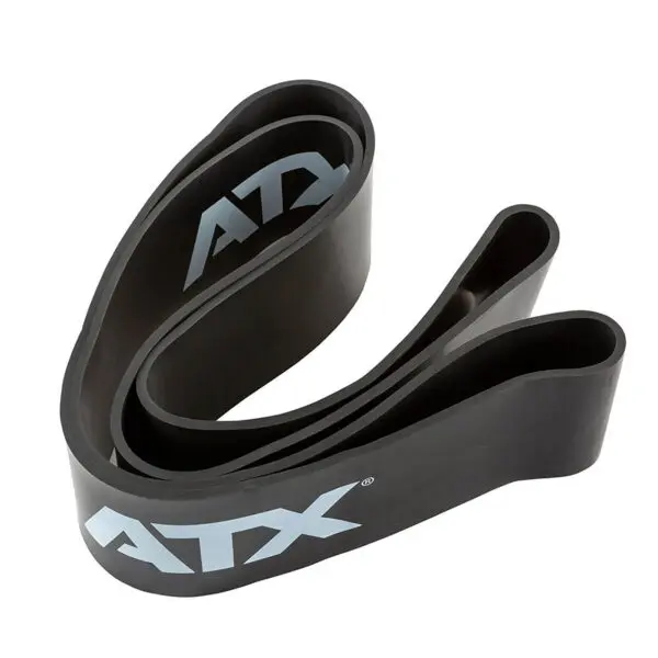 An ATX® Power Band Level Black 7/80mm features white ATX lettering on a black surface. The band is coiled in a folded loop, highlighting its flat, wide design ideal for strength training exercises.