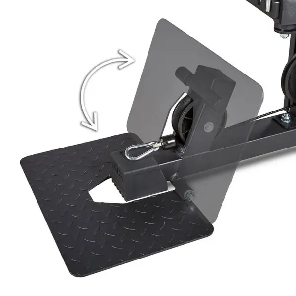 Close-up of the ATX® MultipleX Multi Gym - 700s black metal pedal mechanism, featuring a textured surface and a hook attachment. An arrow indicates its swiveling motion, with clear panels displaying internal components.