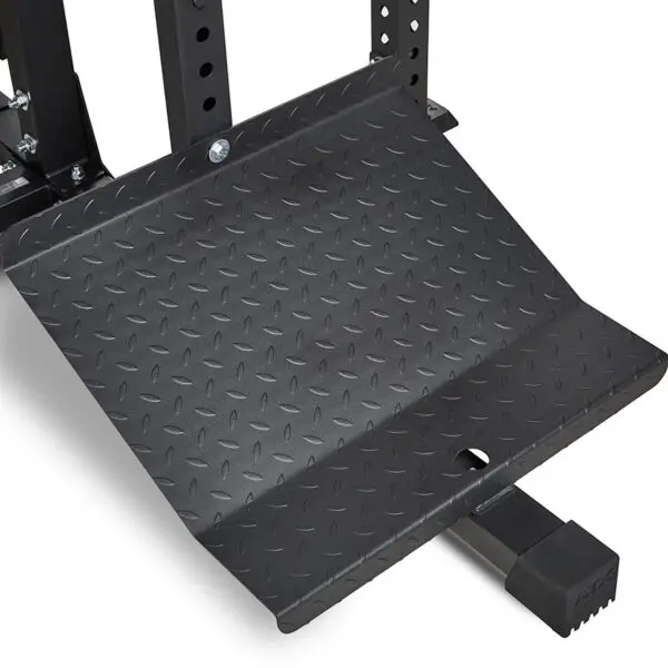 Close-up of the black, textured steel foot plate from the ATX® MultipleX Multi Gym - 700. It features a diamond pattern design for secure footing and grip, commonly found in gym equipment.
