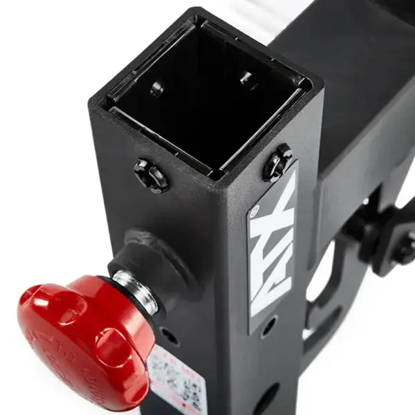 Close-up of the ATX® Commercial FID Bench ATX-MBX-660 with a red handle and black metal resembling a flat incline bench, featuring a square opening for towing or attachment, and displaying the brand logo.