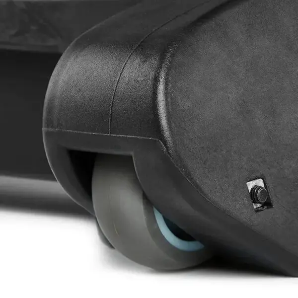 Close-up of a suitcase wheel featuring a sleek, grey caster, echoing the robust design of the ATX® Commercial FID Bench ATX-MBX-660. The wheel is mounted at the corner, displaying its hard plastic casing and a small screw.