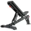 The ATX® Commercial FID Bench ATX-MBX-660 is a black flat incline bench with padded seating, a sturdy metallic frame, visible adjustment notches, and a distinctive red adjustment knob for versatile workouts.