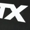 Close-up of a black textured surface on the ATX® Commercial FID Bench ATX-MBX-660, featuring large white TX letters boldly printed on it.