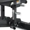 Close-up of the ATX® Commercial FID Bench ATX-MBX-660 mechanism with metal handles and a warning label. The matte black finish and adjustable bolts ensure stability for strength training, making it ideal for use with a flat incline bench setup.